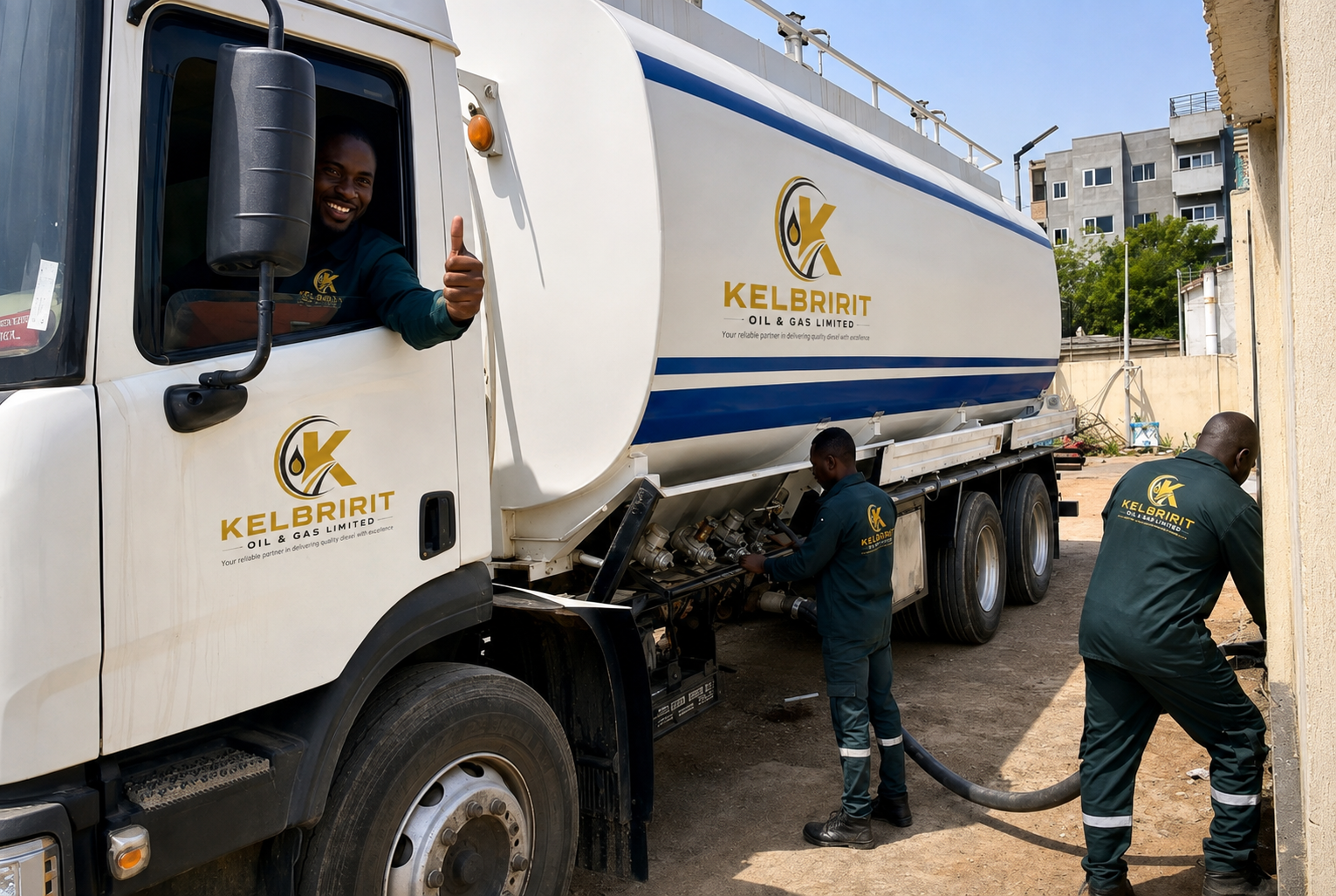 A KELBRIRIT driver gives a thumbs up from the cab while two crew members connect the delivery hose to the tanker.